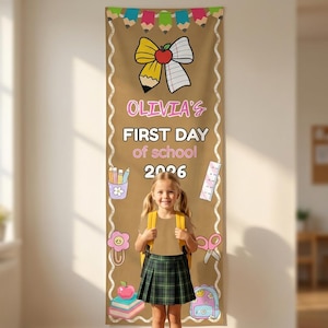May include: A vertical tan banner featuring a colourful pencil border, a central apple-pencil bow graphic, and the text OLIVIA'S FIRST DAY of school 2026. The design includes illustrations of a pencil cup, ruler, paperclip, scissors, and books.