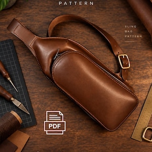 May include: A brown leather sling bag with a single adjustable strap and a brass buckle. The image includes text reading LEATHER BAG PATTERN, SLING BAG PATTERN, and PDF, alongside leather crafting tools like a cutting mat, knife, and ruler.