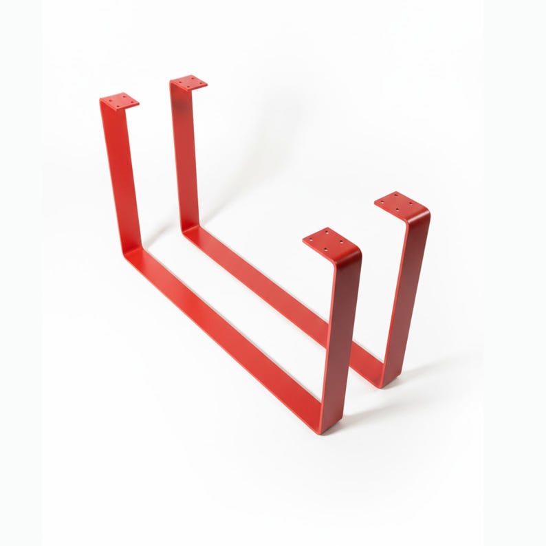May include: Two U-shaped furniture legs finished in a vibrant red powder coating. Each leg features a flat mounting plate at the top with four pre-drilled holes for attachment, constructed from solid metal with a smooth, uniform matte surface.