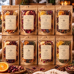 May include: Eight brown kraft paper pouches containing dried fruit, spices, and flowers for simmer pot kits. Each label lists ingredients like orange slices, cinnamon sticks, and cloves, with titles such as Winter Wellness and Spiced Harmony.