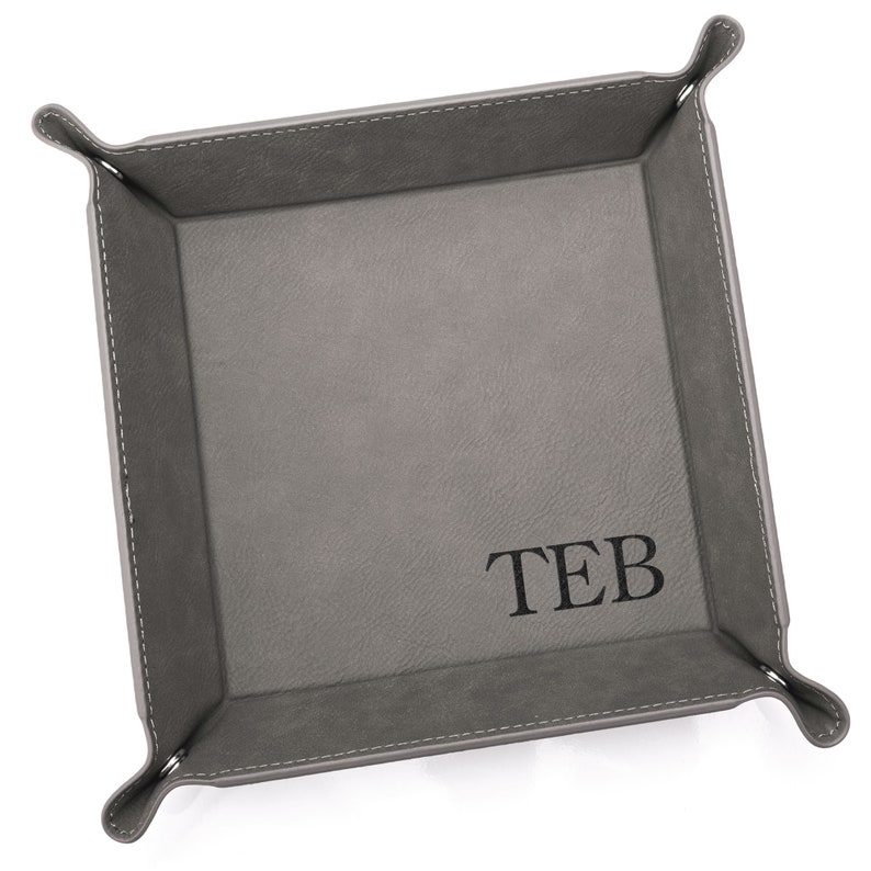 Our monogrammed catchall valet tray by Lifetime Creations is the perfect place for them to drop their keys, change, cash, or other knick-knacks when they get home. Engraved with your recipient's initials, the tray makes an impressive gift.