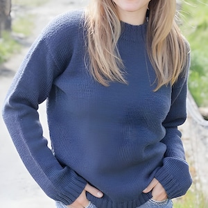 Könnte beinhalten: Ein langärmeliger, dunkelblauer Strickpullover mit geripptem Stehkragen, gerippten Bündchen und einem gerippten Saum. Das Kleidungsstück ist mit einem strukturierten Strickmuster am Körper und an den Ärmeln gefertigt und hat eine einheitliche Farbe.