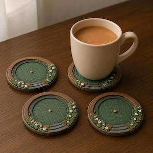 May include: Three circular coasters featuring a green round door design with a central gold knob, brown frame, and small grey steps. Each coaster is decorated with green foliage and white flowers. One coaster supports a beige ceramic mug of tea.