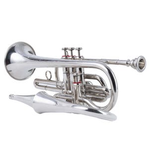 May include: A shiny silver cornet with three valves and a detachable mouthpiece. The brass instrument has a curved design and is set against a white background. The valves have red accents.