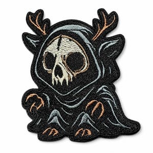 May include: An embroidered patch featuring a stylized character with a skull face, wearing a black hooded cloak and sporting brown antlers. The design includes light blue and white thread details on the black fabric, with a dark border outline.