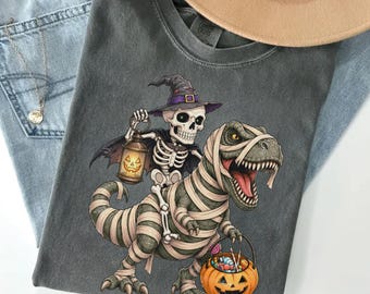 Witch Skeleton Riding Mummy T-Rex Shirt, Funny Halloween Gift, Spooky Dinosaur Tee, Retro Dinosaur Lover Sweatshirt