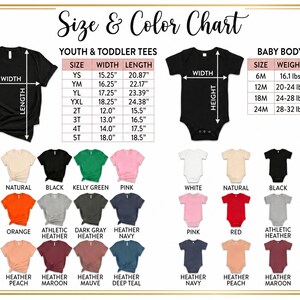 The image is a size and color chart that provides measurements and color options for youth and toddler tees, as well as baby bodysuits. It includes a variety of t-shirt designs in different colors and styles, such as natural, black, pink, white, navy, and peach. The chart provides specific measurements for each size and color, allowing for easy comparison and selection of the desired size and color.