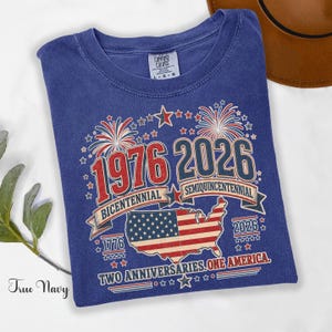 True Navy Comfort Colors t-shirt featuring a vintage patriotic 1976 Bicentennial vs 2026 Semiquincentennial design with bold 1776–2026 text, American flag graphic, fireworks, and USA map, worn as a stylish patriotic outfit for Independence Day, July 4th celebrations, USA 250th anniversary events, and perfect as a 1976 birthday gift or turning 50 t-shirt for those proud of American history and heritage