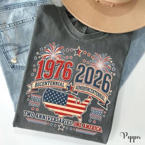 a gray t-shirt with a graphic design celebrating the 1976 Bicentennial and 2016 Semiqu centennial events in the United States.
