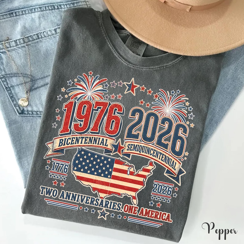 a gray t-shirt with a graphic design celebrating the 1976 Bicentennial and 2016 Semiqu centennial events in the United States.