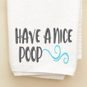 Puede incluir: Toalla de mano blanca con el texto "Have a nice poop" bordado en gris con un diseño de remolino azul.