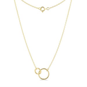 May include: A gold necklace with two linked circles. The necklace has a fine chain and a spring ring clasp. The circles are different sizes, with a smaller circle inside a larger one. The chain is approximately 45 cm long.