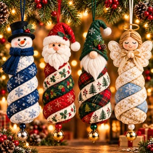 May include: Four hanging Christmas ornaments featuring a snowman with a top hat, Santa Claus, a gnome with a pointed hat, and an angel with wings. Each figure has a quilted, spiraled body and a small gold bell attached to the bottom base.