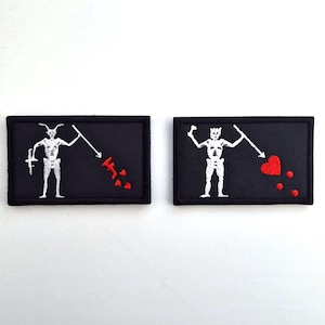 May include: A set of three ceramic mugs with a speckled, matte finish. The mugs are in shades of cream, light gray, and dark gray. Each mug has a simple, minimalist design and a rounded handle.