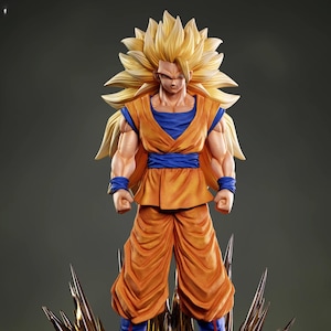May include: A detailed figurine of a character with spiky, golden hair and orange and blue attire. The figure stands on a rocky base with sharp, golden accents. The character has a determined expression.