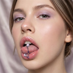 May include: A white ceramic mug with a black handle and the text "But First, Coffee" in a black, bold font. The mug is on a white surface.