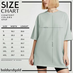 May include: A size chart for Comfort Colors 1717 t-shirts, with measurements in inches. The chart lists sizes S through 4XL, with width and length dimensions. A person is wearing a light green t-shirt. The brand name "boldandgold" is at the bottom.
