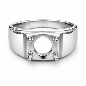 May include: A polished silver ring with a square setting designed to hold a round gemstone. The ring has a thick band and four prongs to secure the stone. The setting has a circular opening.