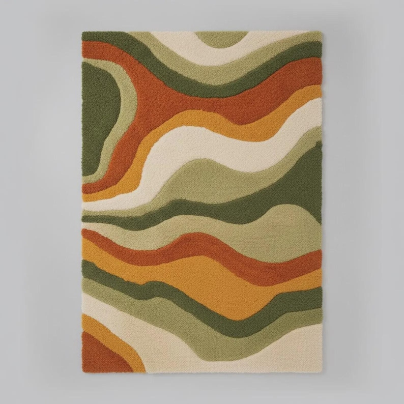 Abstract wave shaggy rug in olive green, orange, and cream colors placed in a modern living room with beige sofa and large windows