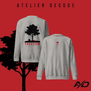 May include: Two heather gray sweatshirts with black and red graphics. One features a tree silhouette with the word "FREEDOM" and the text "noun / frē-dəm". The other has a red tree graphic and the number "654". The brand name "ATELIER DECODE" is at the top.