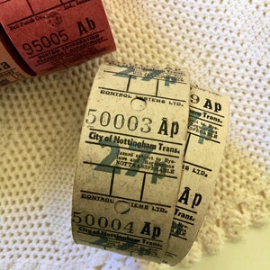 May include: Close-up of three vintage paper tickets with the text "City of Nottingham Trans." and the numbers "95005", "50003", and "50004". The tickets are brown and white with black text.