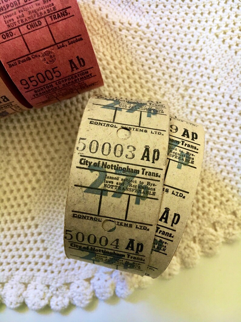 May include: Close-up of three vintage paper tickets with the text "City of Nottingham Trans." and the numbers "95005", "50003", and "50004". The tickets are brown and white with black text.