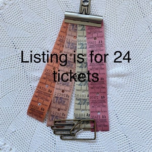 May include: A collection of 24 vintage bus tickets from the City of Nottingham Transport Department. The tickets are in various colors, including pink, orange, and white. The tickets are held together with a metal clip.