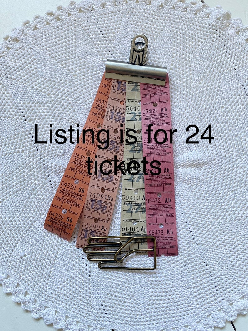 May include: A collection of 24 vintage bus tickets from the City of Nottingham Transport Department. The tickets are in various colors, including pink, orange, and white. The tickets are held together with a metal clip.