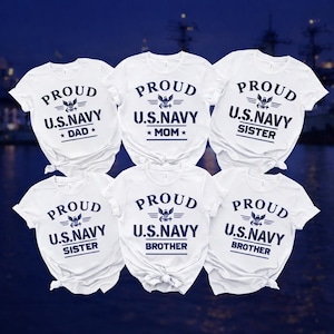 May include: Six white t-shirts with navy blue text and graphics. Each shirt reads "PROUD U.S. NAVY" with a family member title: Dad, Mom, and Sister (x2), and Brother (x2). The shirts have a classic crew neck design.