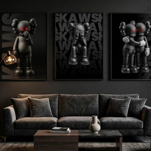 May include: Three framed black and white art prints featuring stylized figures with red 'X' eyes and hands covering their faces. The prints hang above a dark grey sofa with matching throw cushions. A modern floor lamp and a coffee table complete the room's decor.