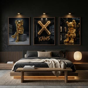 May include: Three framed art prints showcasing gold KAWS figures and a gold "X" balloon design against a dark backdrop. The prints are displayed above a bed with a wooden frame and a neutral-toned rug.