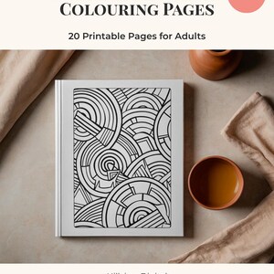 May include: A white book with black geometric designs, titled "ANGULAR GEOMETRY COLOURING PAGES" with "20 Printable Pages for Adults." A small, round, pink "Instant Download" sticker is in the upper right corner. A small brown bowl and a terracotta pot are also visible.