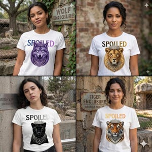 Puede incluir: Cuatro camisetas blancas con la palabra "SPOILED" y gráficos de animales. Los diseños muestran un lobo, un león, una pantera y un tigre, cada uno adornado con una corona. Las camisetas se presentan frente a una exhibición de zoológico.