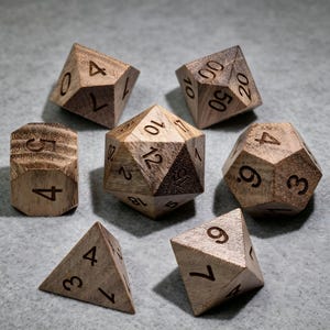 May include: A set of seven polyhedral dice crafted from light brown wood with visible grain patterns and dark engraved numbers. The collection includes a d20, d12, d10, d10 percentile, d8, d6, and d4, each featuring sharp geometric edges and clear numerical markings.