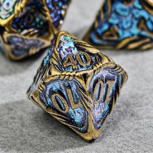 May include: Close-up of a multi-sided die with the number 40 visible. The die has a gold-colored trim and iridescent blue and purple coloring. The die is designed for role-playing games.