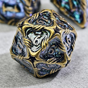 May include: A multi-faceted, iridescent die with a swirling pattern of gold and black. The numbers are white. The die is a gaming accessory.