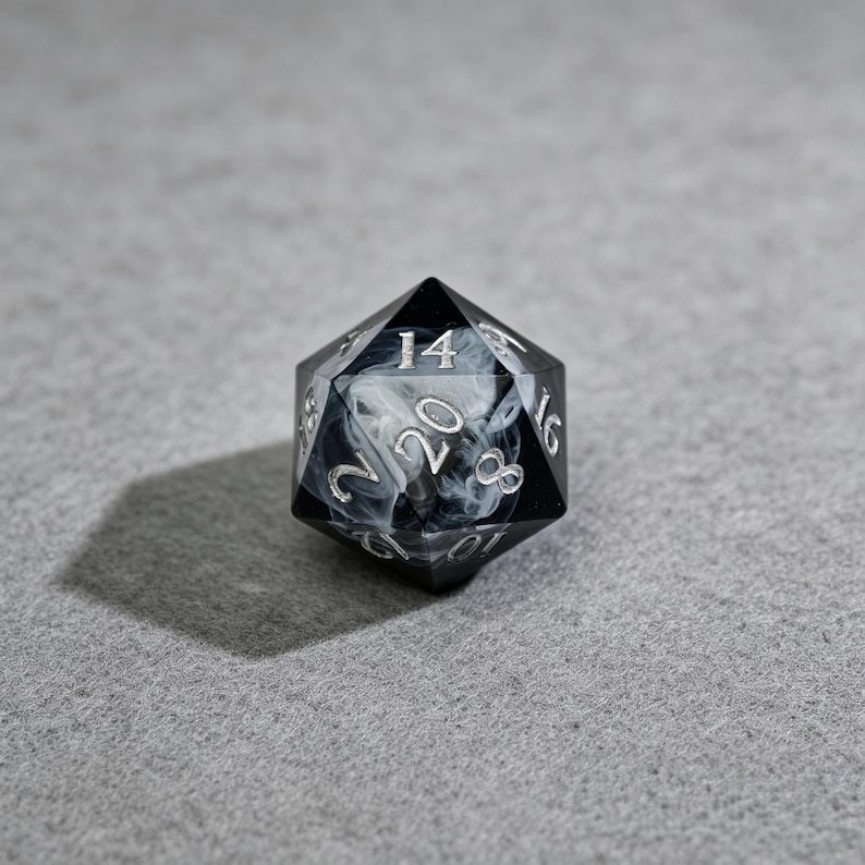 May include: A black and white marbled twenty-sided die, with silver numerals. The die is set against a gray background, casting a shadow. The numbers 2, 8, 14, 16, and 20 are visible.