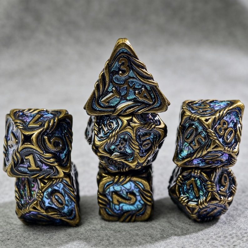 May include: Set of seven polyhedral dice in a fantasy style. The dice are a mix of blue and gold with intricate designs and numbering. The d20 is a pyramid shape, and the other dice are various geometric shapes.