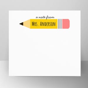 May include: White stationery with a yellow pencil design. The pencil has a black tip, a yellow body, and a pink eraser. The text "a note from MRS. ANDERSON" is printed on the stationery.