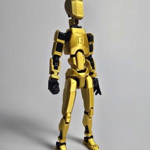Side profile of the 8-inch Gold Artist model. Notice the seamless armor fit and anatomical precision across the torso and limbs.