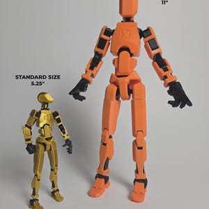 Comparison of the 5.25" Silk Gold Standard figure next to the 11" Orange Titan figure showing the size relationship between the two figures.