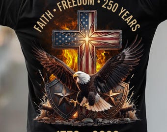 May include: Black t-shirt featuring a patriotic design with a cross, American flag, and an eagle with outstretched wings. The shirt includes the text "Faith, Freedom, 250 Years" and the years "1776-2026".
