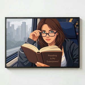May include: Framed artwork depicting a woman with brown hair and glasses reading a book. The book is open, with the text "Reading is My Superpower!". A cityscape and blue seat are visible in the background.