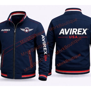 May include: Navy blue bomber jacket with red and white accents. Features the text "AVIREX USA" on the chest, sleeves, and back. Includes a star and wing emblem. A classic, sporty design.