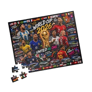 May include: A rectangular jigsaw puzzle featuring the World Cup 2026 logo, the FIFA trophy, and various soccer players. The design includes text such as "United as One," "3 Nations, 16 Host Cities, 1 World," and images of stadiums, national flags, and fireworks.