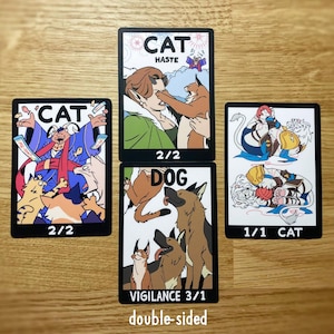 May include: Four rectangular game cards with black borders featuring colourful cartoon illustrations of cats and dogs. The cards display text including CAT HASTE 2/2, CAT 2/2, DOG VIGILANCE 3/1, and 1/1 CAT. The artwork depicts various feline and canine characters in dynamic poses, with some cards showing multiple animals interacting.