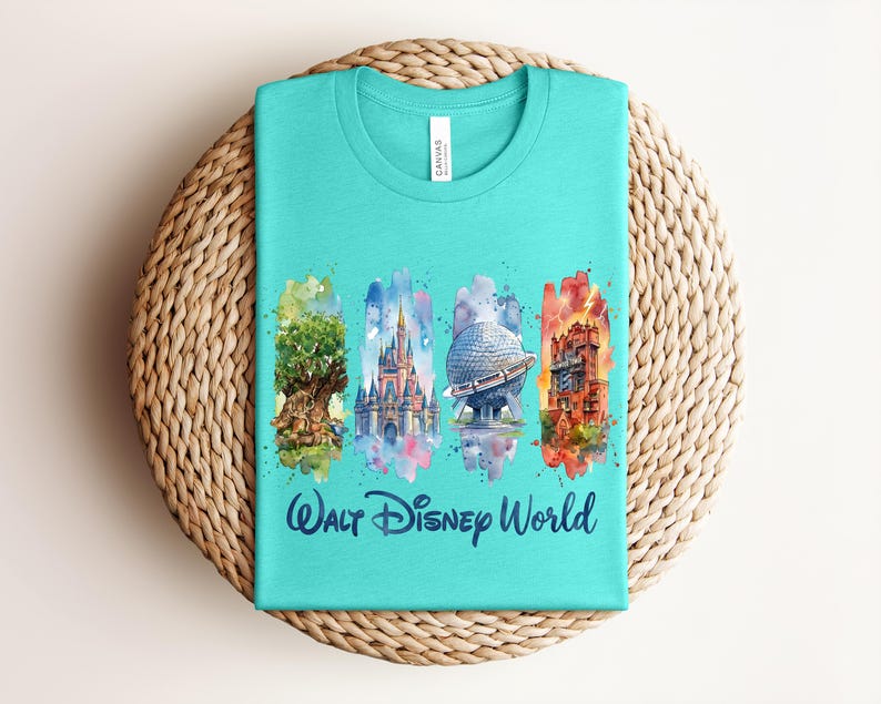 May include: A turquoise t-shirt featuring watercolor illustrations of iconic Walt Disney World landmarks. The design includes the Tree of Life, Cinderella Castle, Spaceship Earth, and Tower of Terror, with "Walt Disney World" text below.