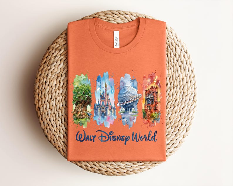 May include: Orange t-shirt featuring watercolor illustrations of iconic Walt Disney World landmarks. The design includes the Tree of Life, Cinderella Castle, Spaceship Earth, and the Tower of Terror, with "Walt Disney World" in script.