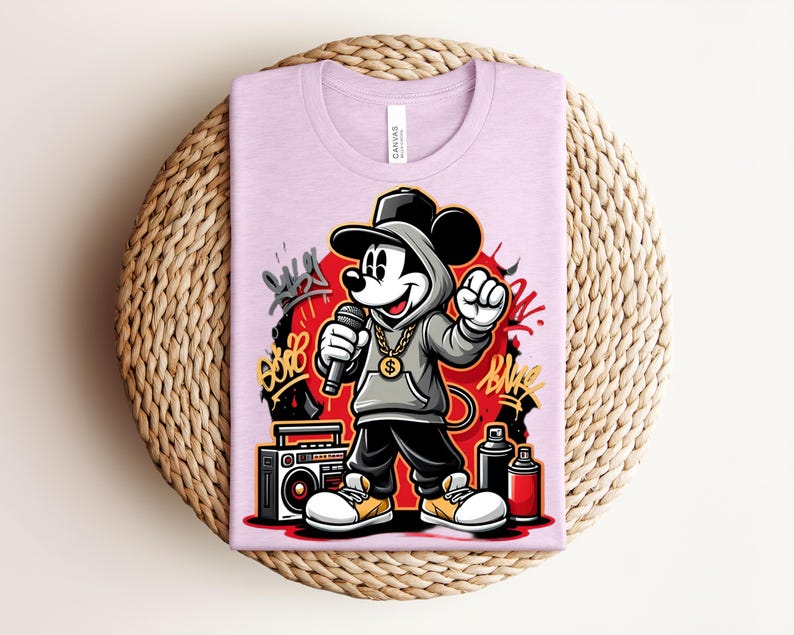May include: A light purple t-shirt featuring a cartoon Mickey Mouse in a hip-hop style. Mickey is wearing a gray hoodie, black pants, and a gold chain, holding a microphone. Graffiti art and a boombox are also visible.