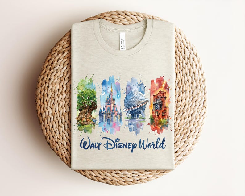 May include: A light beige t-shirt featuring a watercolor design of Walt Disney World landmarks. The design includes the Tree of Life, Cinderella Castle, Spaceship Earth, and the Tower of Terror, with "Walt Disney World" written below.